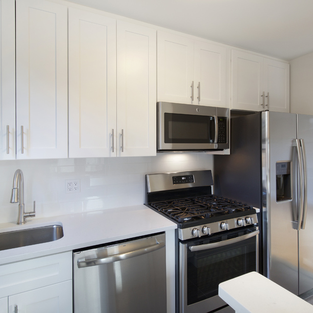 Biltmore Plaza - White Kitchen Cabinets and Metallic Appliances