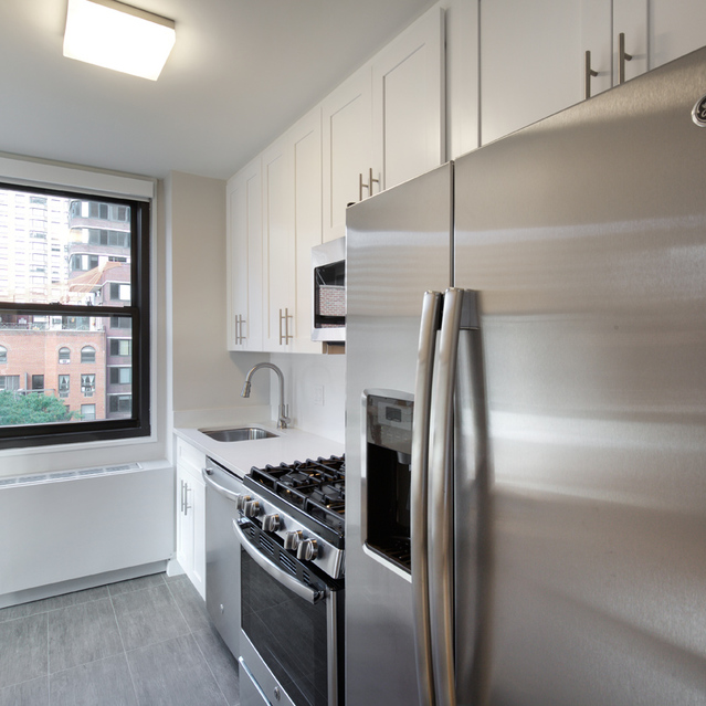 Biltmore Plaza - White Kitchen Cabinets and Metallic Appliances